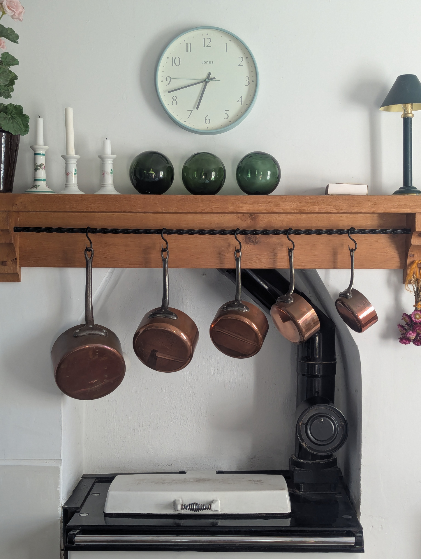 Copper pans hanging above the Rayburn in the kitchen.